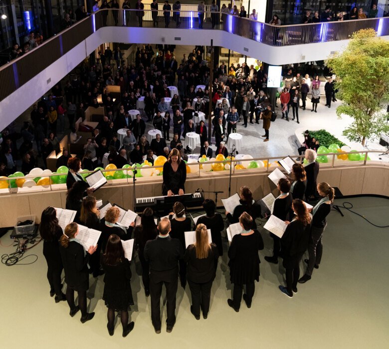 choir performing in the atrium of Biomedicum at the inauguration. Audience is spread out on different levels of the building.