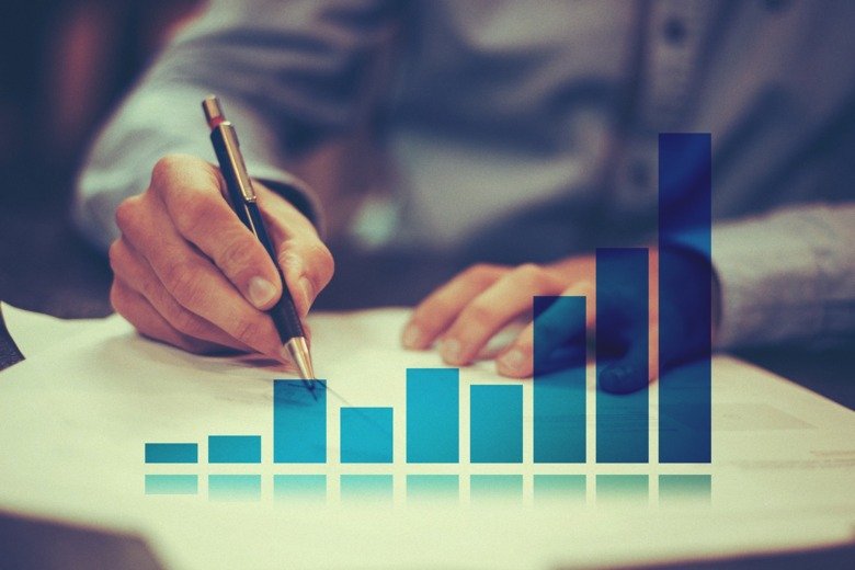 Hands writing, illustrating statistics and planning.