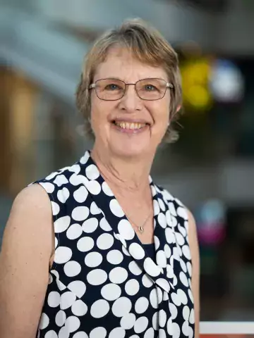 Photo of smiling woman with glasses.