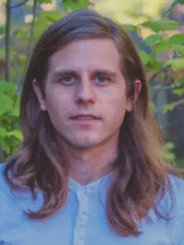 Photo of man with long hair.